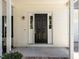 A welcoming covered porch leads to the front door, framed by sidelights at 620 Hanska Way, Raleigh, NC 27610