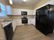 Kitchen featuring granite countertops, stainless steel appliances, and white cabinets at 620 Hanska Way, Raleigh, NC 27610