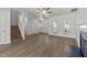 Bright living room with fireplace, hardwood floors, and a ceiling fan at 620 Hanska Way, Raleigh, NC 27610
