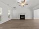 Living room with a fireplace, hardwood floors, and lots of natural light at 620 Hanska Way, Raleigh, NC 27610