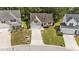 Aerial view of a single-Gathering home featuring a manicured lawn and a paved driveway at 633 Prickly Pear Dr, Fuquay Varina, NC 27526