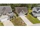 Aerial view showcasing a well-maintained yard, mature trees, and neighboring homes at 633 Prickly Pear Dr, Fuquay Varina, NC 27526