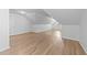 Bright attic space featuring wood-look floors, slanted ceilings, and natural light at 633 Prickly Pear Dr, Fuquay Varina, NC 27526