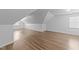 Attic featuring wood-look floors and a window for natural light at 633 Prickly Pear Dr, Fuquay Varina, NC 27526