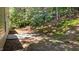Backyard patio and tree lined property featuring a cement slab for outdoor living at 633 Prickly Pear Dr, Fuquay Varina, NC 27526