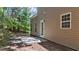 Backyard patio and tree lined property featuring a cement slab for outdoor living at 633 Prickly Pear Dr, Fuquay Varina, NC 27526
