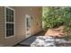 Backyard patio and tree lined property featuring a cement slab for outdoor living at 633 Prickly Pear Dr, Fuquay Varina, NC 27526