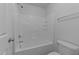 Clean bathroom showcasing a shower-tub combo with white tile and fixtures at 633 Prickly Pear Dr, Fuquay Varina, NC 27526