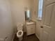 Powder room featuring a vanity, mirror, and toilet at 633 Prickly Pear Dr, Fuquay Varina, NC 27526