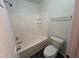 Bathroom featuring a white tub and toilet combination with wood-look flooring at 633 Prickly Pear Dr, Fuquay Varina, NC 27526