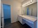 Bathroom featuring a spacious light-stone countertop with vanity and an open door to a walk-in closet at 633 Prickly Pear Dr, Fuquay Varina, NC 27526