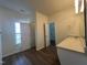 Bathroom with a light stone countertop, wooden floors, and access to the toilet and a large closet at 633 Prickly Pear Dr, Fuquay Varina, NC 27526