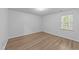 Bedroom featuring neutral walls, wood-look floors, and a window with natural light at 633 Prickly Pear Dr, Fuquay Varina, NC 27526
