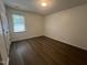 This bedroom features hardwood floors, a window for natural light, and a neutral color palette at 633 Prickly Pear Dr, Fuquay Varina, NC 27526