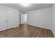 Bedroom with hardwood flooring, a double-door closet, and a doorway to another room at 633 Prickly Pear Dr, Fuquay Varina, NC 27526