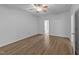 A spacious bedroom featuring wood-look floors, white walls, and natural light at 633 Prickly Pear Dr, Fuquay Varina, NC 27526