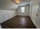 Bedroom featuring hardwood floors, a window for natural light, and storage access at 633 Prickly Pear Dr, Fuquay Varina, NC 27526