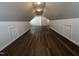 Large bonus room with wood floors, dormer windows for natural light, and ample storage space at 633 Prickly Pear Dr, Fuquay Varina, NC 27526