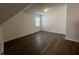 Bonus room with hardwood floors, a window for natural light, and neutral paint throughout at 633 Prickly Pear Dr, Fuquay Varina, NC 27526