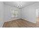 Dining room with wood-look floors, bright lighting, and large window at 633 Prickly Pear Dr, Fuquay Varina, NC 27526