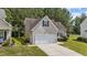 Exterior view showing a light color home featuring an attached garage with green grass at 633 Prickly Pear Dr, Fuquay Varina, NC 27526