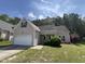 Charming home with a well-manicured lawn, attached garage, and traditional architectural details at 633 Prickly Pear Dr, Fuquay Varina, NC 27526