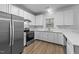 Bright kitchen featuring stainless steel appliances, and white cabinetry at 633 Prickly Pear Dr, Fuquay Varina, NC 27526