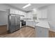 Kitchen with stainless steel appliances, ample counter space, and white cabinetry at 633 Prickly Pear Dr, Fuquay Varina, NC 27526
