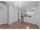 Open kitchen with stainless appliances, white cabinets, and wood-look flooring at 633 Prickly Pear Dr, Fuquay Varina, NC 27526