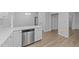Kitchen island with stainless steel dishwasher and wood-look floors at 633 Prickly Pear Dr, Fuquay Varina, NC 27526