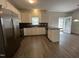 Modern kitchen featuring stainless steel appliances, granite countertops, and ample cabinet space at 633 Prickly Pear Dr, Fuquay Varina, NC 27526