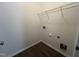 Neutral-toned laundry room featuring modern wood-look flooring and a wire shelf for storage at 633 Prickly Pear Dr, Fuquay Varina, NC 27526