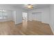Open-concept living space featuring hardwood flooring, with view to the kitchen and chandelier at 633 Prickly Pear Dr, Fuquay Varina, NC 27526