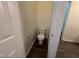 Small powder room with a standard white toilet and wood-look flooring at 633 Prickly Pear Dr, Fuquay Varina, NC 27526