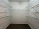 Spacious walk-in closet with wood-look flooring and white wire shelving at 633 Prickly Pear Dr, Fuquay Varina, NC 27526