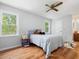 Bedroom with two windows with natural light, wood flooring, and ceiling fan at 6718 Twin Tree Ct, Raleigh, NC 27613
