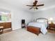Bedroom with carpet flooring, ceiling fan, and ensuite bath at 6718 Twin Tree Ct, Raleigh, NC 27613