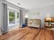 Sunlit Bedroom with wood floors, crib, and large windows at 6718 Twin Tree Ct, Raleigh, NC 27613