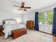 This main bedroom offers carpet flooring, ceiling fan, and natural light at 6718 Twin Tree Ct, Raleigh, NC 27613