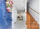 Inviting entryway with tile flooring, wooden staircase, and a vibrant floral wreath on the front door at 6718 Twin Tree Ct, Raleigh, NC 27613