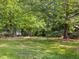 Expansive front yard with mature trees, offering shade and a tranquil setting at 6718 Twin Tree Ct, Raleigh, NC 27613