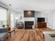Cozy living room features hardwood floors, a modern fireplace, and comfortable seating at 6718 Twin Tree Ct, Raleigh, NC 27613