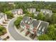 Aerial shot of the brick townhomes, lush landscaping, and the #7 Highlands, creating a serene neighborhood at 703 Kirkeenan Cir, Morrisville, NC 27560