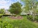Green backyard with mature trees and landscaping providing a serene and private outdoor space at 703 Kirkeenan Cir, Morrisville, NC 27560