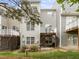 Back exterior view of home featuring private decks, patios, and well-maintained landscaping at 703 Kirkeenan Cir, Morrisville, NC 27560