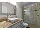 Bathroom featuring granite countertop vanity and sleek glass door shower with decorative tile accents at 703 Kirkeenan Cir, Morrisville, NC 27560