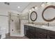 Bathroom featuring a double sink vanity, granite counters and walk-in shower at 703 Kirkeenan Cir, Morrisville, NC 27560