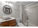 Bathroom featuring vanity with granite counter, a decorative sink, and a tiled shower at 703 Kirkeenan Cir, Morrisville, NC 27560