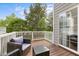 Relaxing outdoor deck with wicker furniture and a view of lush greenery at 703 Kirkeenan Cir, Morrisville, NC 27560