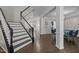 Staircase and foyer featuring hardwood floors, wainscoting details, and an open view to the dining room at 703 Kirkeenan Cir, Morrisville, NC 27560